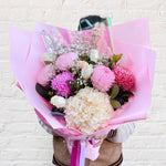 Crimson bouquet featuring red tones of flowers - babys breath, roses, chrysanthemums, alstromerias.