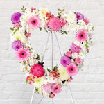 Pink & Lilac Heart Wreath featuring seasonal pink and lilac flowers - roses, gerberas, baby's breath, chrysanthemum, alstromerias, dahlias, greenery