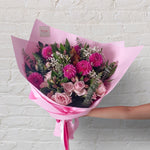 Pretty Pinks bouquet featuring seasonal pink and white flowers with lush greenery