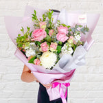 Pretty Pinks bouquet featuring seasonal pink and white flowers with lush greenery
