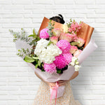 Pretty Pinks bouquet featuring seasonal pink and white flowers with lush greenery