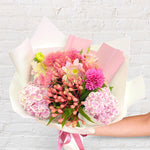 Pretty Pinks bouquet featuring seasonal pink and white flowers with lush greenery