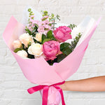 Pretty Pinks bouquet featuring seasonal pink and white flowers with lush greenery