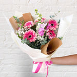 Pretty Pinks bouquet featuring seasonal pink and white flowers with lush greenery