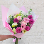 Pretty Pinks bouquet featuring seasonal pink and white flowers with lush greenery