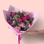 Pretty Pinks bouquet featuring seasonal pink and white flowers with lush greenery