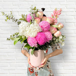 Pretty Pinks flowers in a vase featuring seasonal pink and white flowers with lush greenery