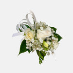 classic white corsage featuring roses, greenery, baby's breath, satin ribbon. Perfect for prom and weddings.