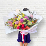 Beautiful seasonal bright and vibrant bouquet with columbian roses, chrysanthemums, dahlia, oriental kale, eucalyptus, lisianthus, snap dragons, carnations and greenery. Flower delivery Sydney. Sydney Florist.