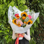 Beautiful seasonal bright and vibrant bouquet with columbian roses, chrysanthemums, sunflowers, tulips, eucalyptus and greenery. Flower delivery Sydney. Sydney Florist.