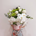 A beautiful bouquet of flowers in greens and whites with hydrangeas, eucalyptus, chrysanthemums, columbian roses, Phalaenopsis orchid. Flower delivery Sydney. Sydney Florist.