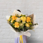 Beautiful seasonal yellow bouquet with columbian roses, chrysanthemums, misty, oriental kale, eucalyptus, lisianthius, alstroemeria, wattle, palm and greenery. Flower delivery Sydney. Sydney Florist.