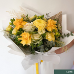 Beautiful seasonal yellow bouquet with columbian roses, chrysanthemums, misty, oriental kale, eucalyptus, lisianthius, alstroemeria, wattle, palm and greenery. Flower delivery Sydney. Sydney Florist.