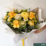 Beautiful seasonal yellow bouquet with columbian roses, chrysanthemums, misty, oriental kale, eucalyptus, lisianthius, alstroemeria, wattle, palm and greenery. Flower delivery Sydney. Sydney Florist. 