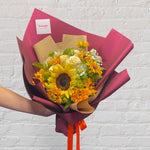 small bouquet featuring yellow and orange flowers - sunflowers, roses, baby's breath