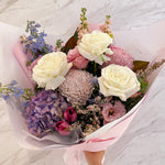 Beautiful seasonal soft and pastel bouquet with hydrangea, columbian roses, magnolia, delphinium, chrysanthemums, tulips, stocks, isianthus and greeenery. Flower delivery Sydney. Sydney Florist.
