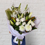 sympathy, housewarming white bouquet featuring coulumbian roses, oriental lillies, disbuds, snap dragons, greenery