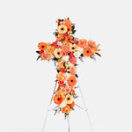 Orange flowers cross wreath with white stand