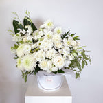 Sympathy white flowers with greenery in a white flower box