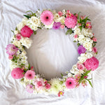 Soft pink and lilac round wreath with white stand