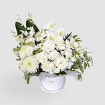 Sympathy white flowers with greenery in a white flower box