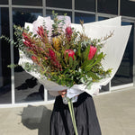 Beautiful seasonal native bouquet with proteas, eucalyptus, leucadendrons, banksia. Flower delivery Sydney. Sydney Florist. 