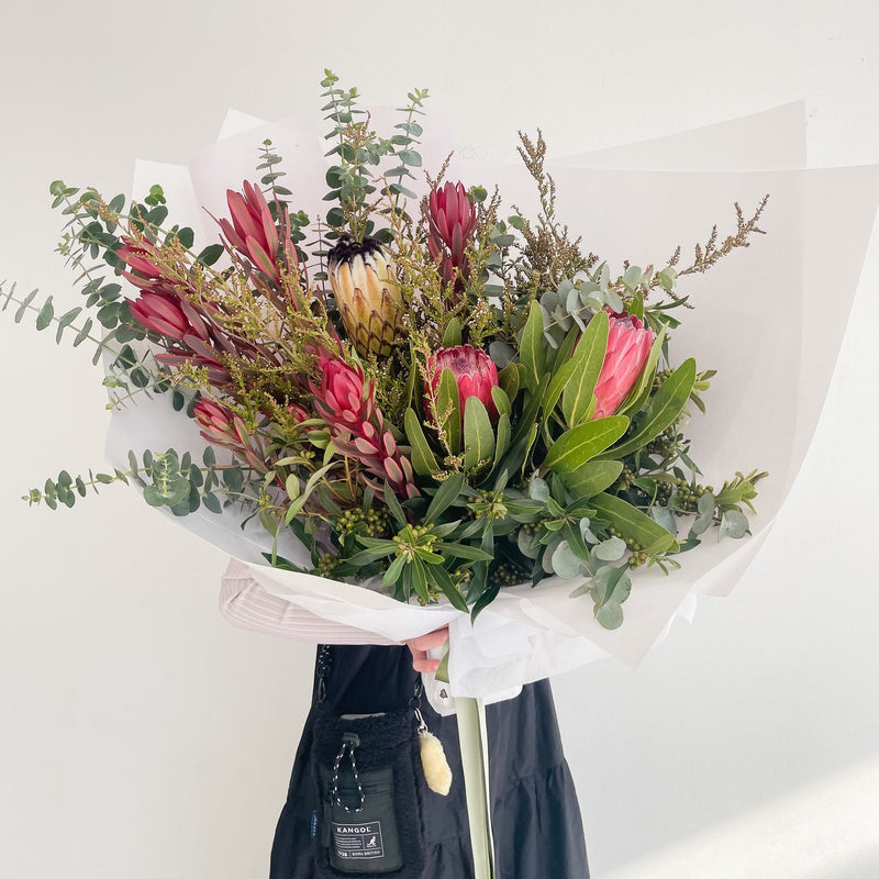 Beautiful seasonal native bouquet with proteas, eucalyptus, leucadendrons, banksia. Flower delivery Sydney. Sydney Florist. 