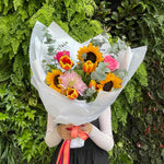 Beautiful seasonal bright and vibrant bouquet with columbian roses, chrysanthemums, sunflowers, tulips, eucalyptus and greenery. Flower delivery Sydney. Sydney Florist. 