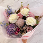 Beautiful seasonal soft and pastel bouquet with hydrangea, columbian roses, magnolia, delphinium, chrysanthemums, tulips, stocks, isianthus and greeenery. Flower delivery Sydney. Sydney Florist. 