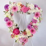 Pink & Lilac Heart Wreath featuring seasonal pink and lilac flowers - roses, gerberas, baby's breath, chrysanthemum, alstromerias, dahlias, greenery 
