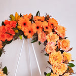 Two toned orange, yellow and white flowers round wreath closeup 