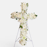 White Cross Wreath featuring white seasonal flowers - roses, alstromeria, lisianthus, chrysanthemums 