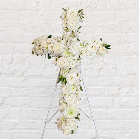 White Cross Wreath featuring white seasonal flowers - roses, alstromeria, lisianthus, chrysanthemums 