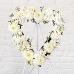 White flowers heart wreath featuring roses, dahlias, chrysanthemum, lisianthus, greenery. 