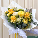 Beautiful seasonal yellow bouquet with columbian roses, chrysanthemums, misty, oriental kale, eucalyptus, lisianthius, alstroemeria, wattle, palm and greenery. Flower delivery Sydney. Sydney Florist. 