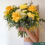 Beautiful seasonal yellow bouquet with columbian roses, chrysanthemums, misty, oriental kale, eucalyptus, lisianthius, alstroemeria, wattle, palm and greenery. Flower delivery Sydney. Sydney Florist. 