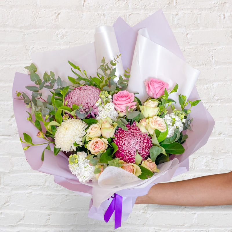 purple bouquet featuring seasonal flowers - roses, chrysanthemum, stock, eucalyptus and eucalyptus 