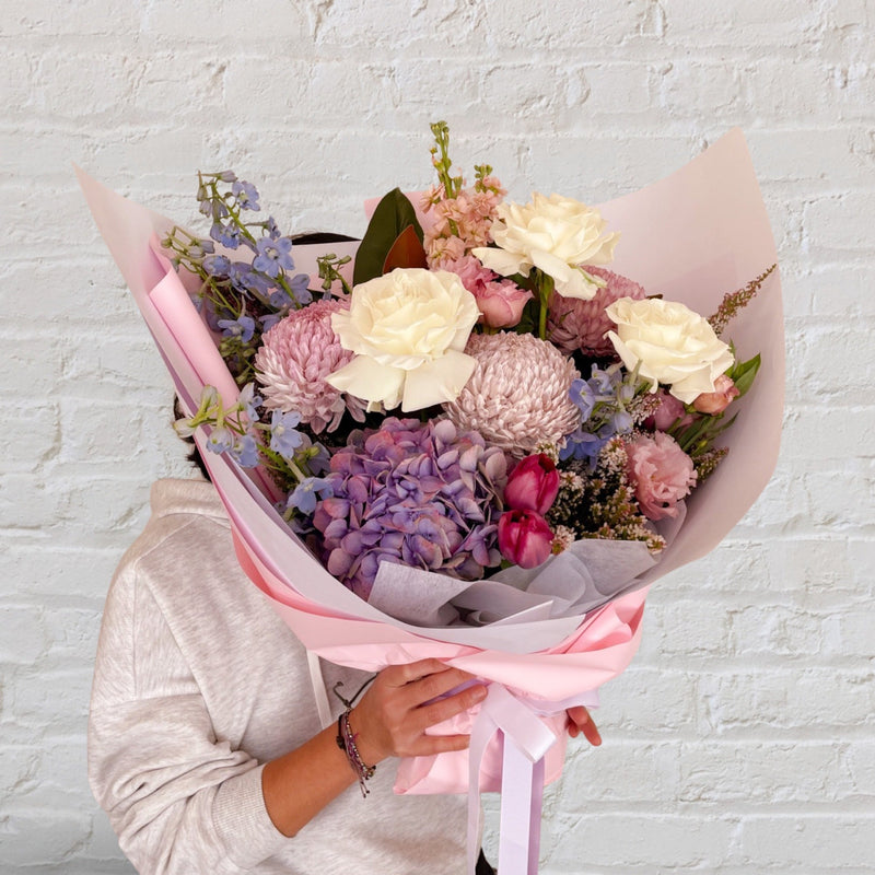 soft and pretty bouquet featuring soft pastel seasonal flowers 