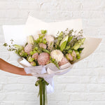 soft blush bouquet featuring roses, chrysanthemum, lilies, lisianthus, greenery 