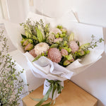 soft blush bouquet featuring roses, chrysanthemum, lilies, lisianthus, greenery 