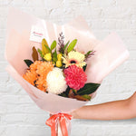 sunset orange bouquet featuring seasonal flowers - roses, dahlias, greenery, gerbera, tiger lily, 