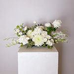 white & greens table centerpiece featuring seasonal flowers - roses, disbuds, Singapore orchid, spray roses, greenery, snap dragons. 